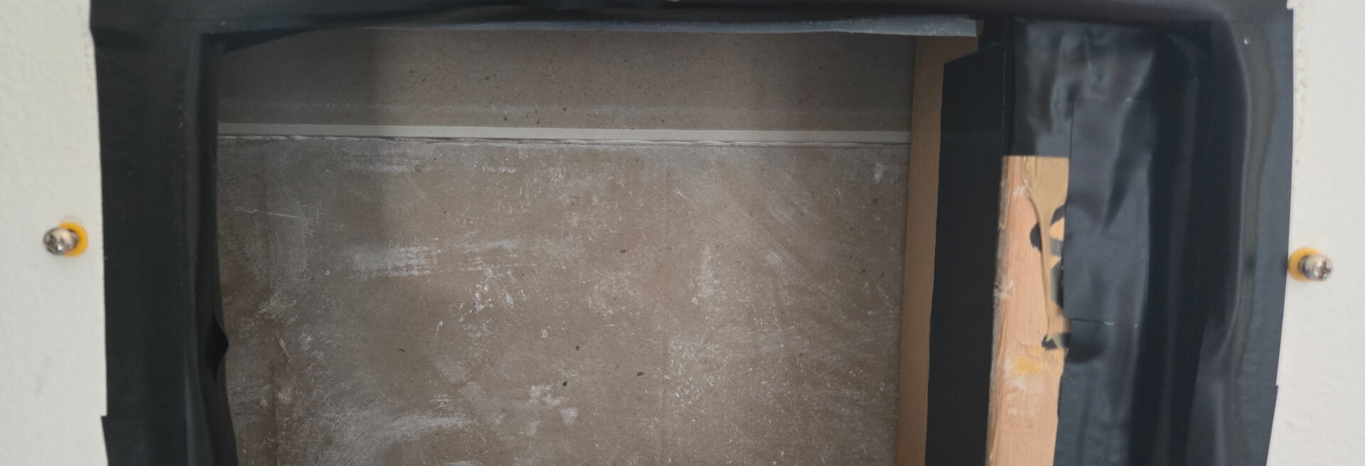 drywall screws and anchors in drywall, to the right and left of a hole